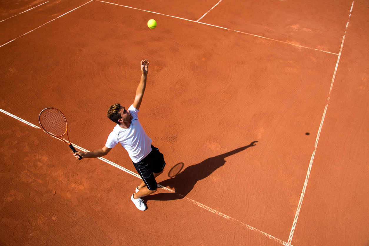 Young man playing tennisYoung man playing tennis