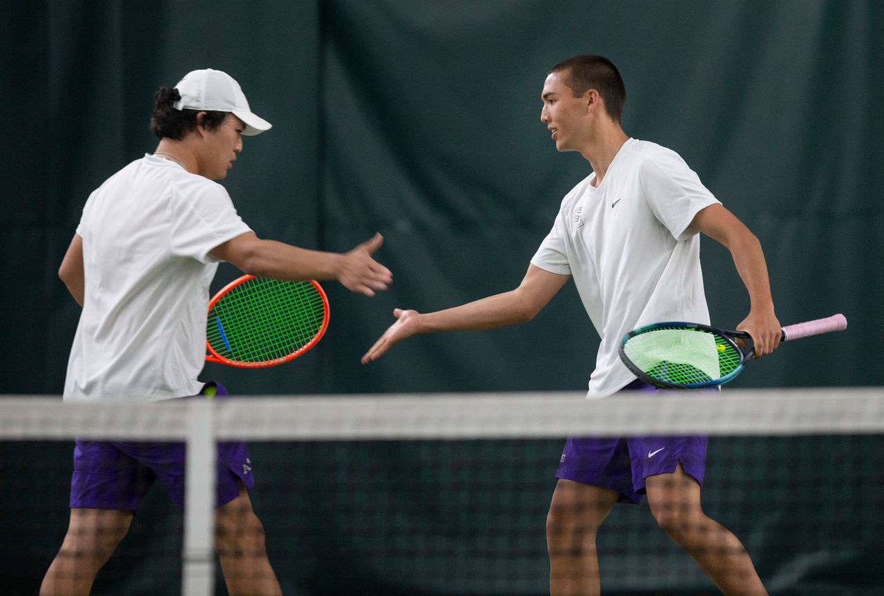 Professional tennis player man playing on court in afternoon.