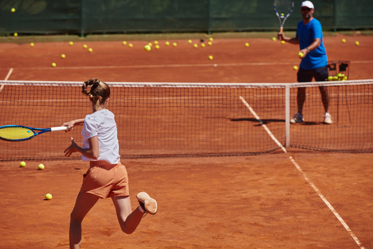 A professional tennis player and her coach training on a sunny day at the tennis court. Training and preparation of a professional tennis player A professional tennis player and her coach training on a sunny day at the tennis court. Training and preparation of a professional tennis player. LicenseRF 20335086 ,model released, Symbolfoto Copyright: xZoonar.com/BENISxARAPOVICx 20335086 ,model released, Symbolfoto ,property released